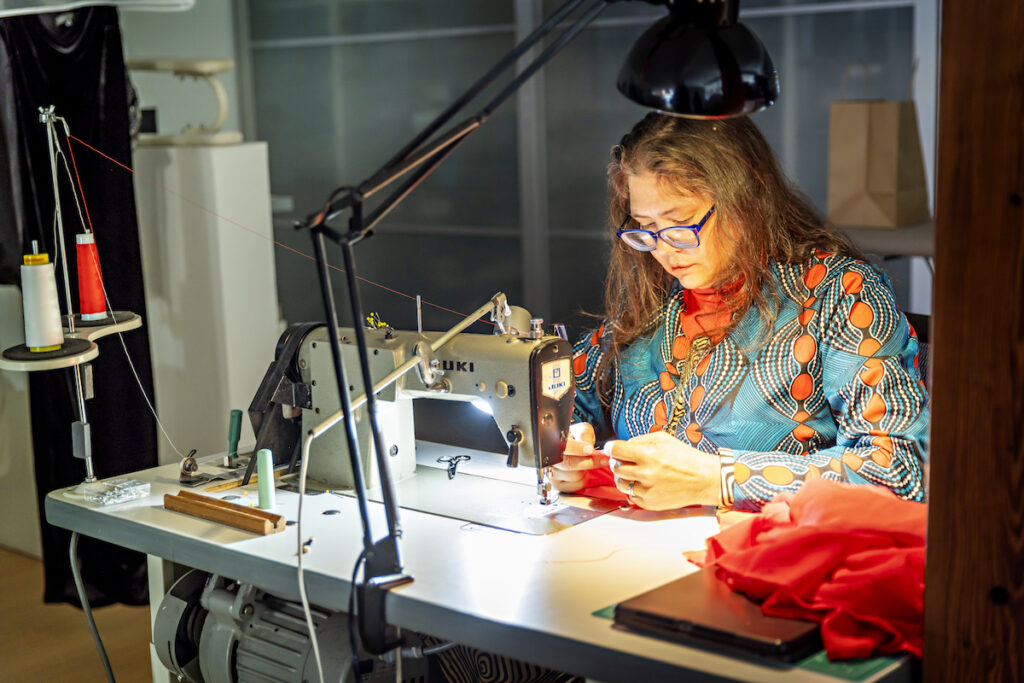 Master seamstress and technical designer Chrystal Parrot at the sewing machine. 