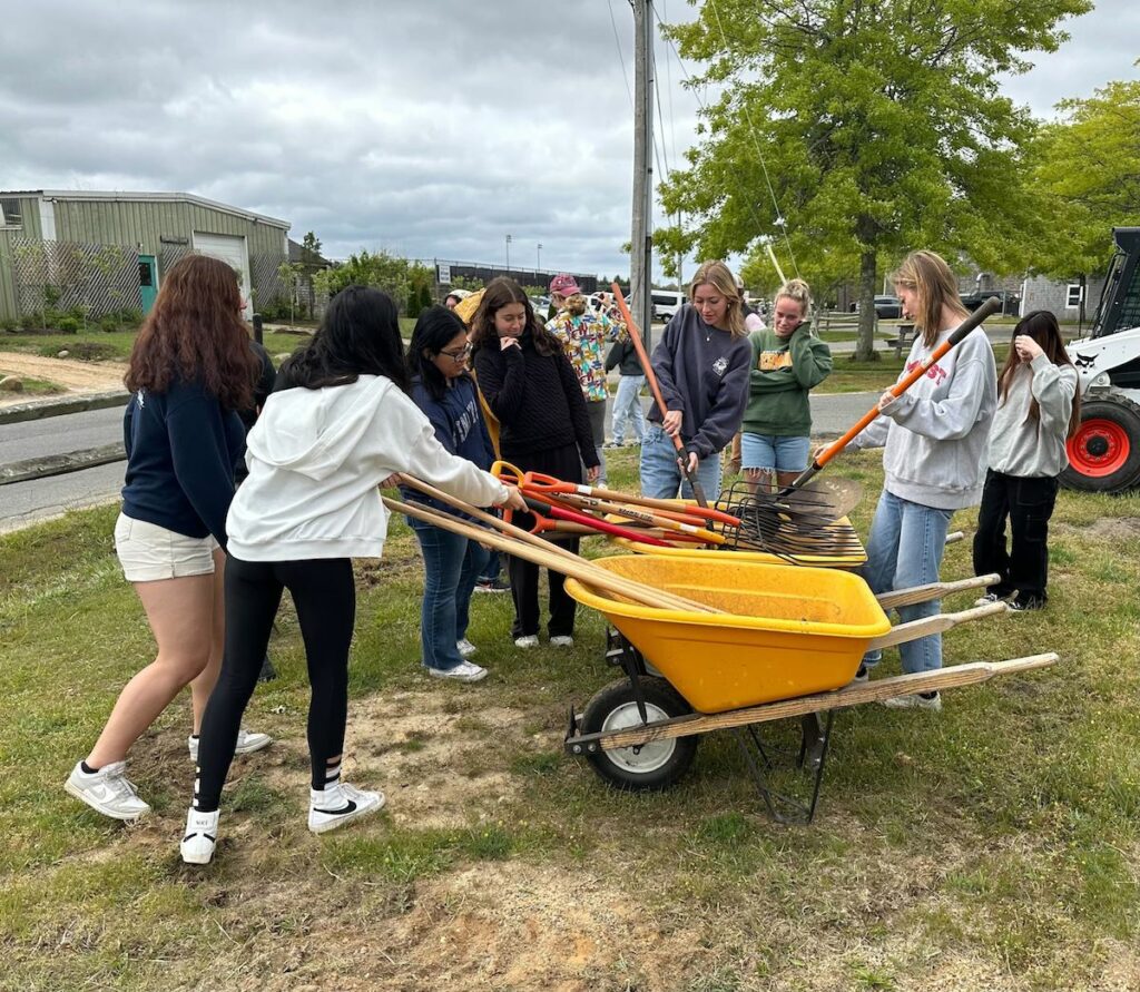 Students at MVRHS prepare to edge new pollinator gardens as part of a workshop led by the school horticulture program.