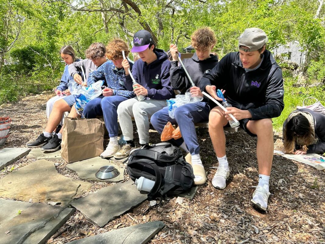 A group of students make eco bricks as part of a workshop at Felix Neck led by Laurisa Rich.