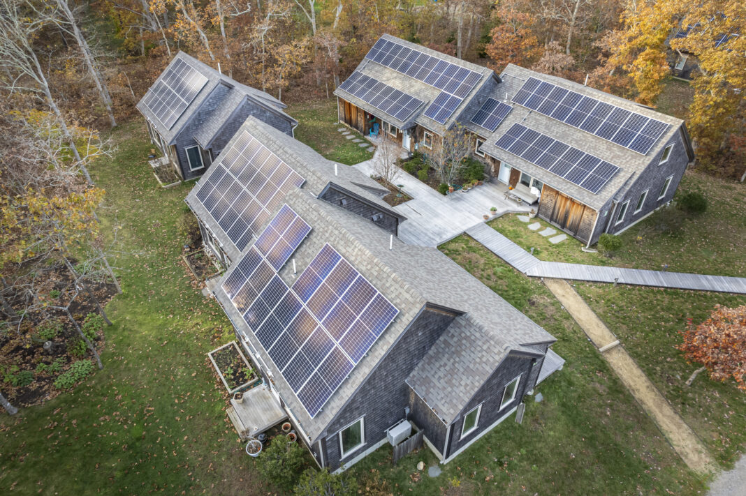 aerial view of houses with solar panels on roof