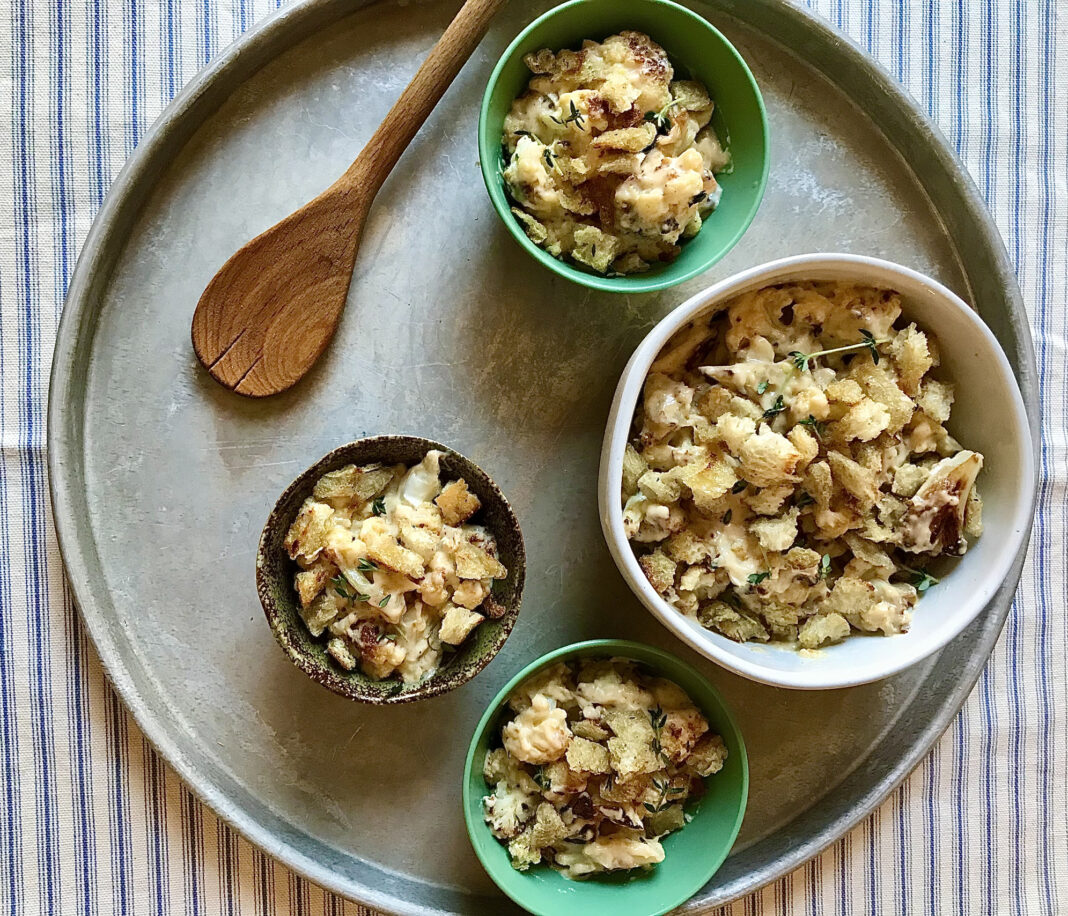 large bowl with smaller bowls of roasted cauliflower and cheese